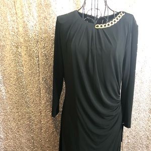 Long sleeve black dress with gold chain accent